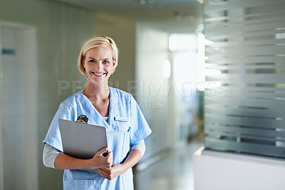 Buy stock photo Portrait of a young female doctor standing in a hospital corridor