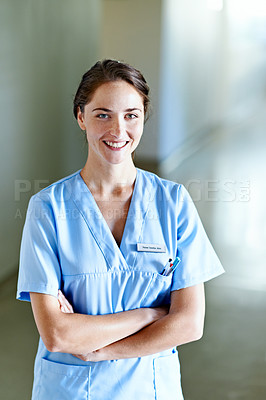 Buy stock photo Portrait of a young female doctor standing in a hospital corridor