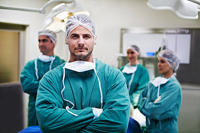 Buy stock photo Portrait of a group of surgeons standing in an operating theater