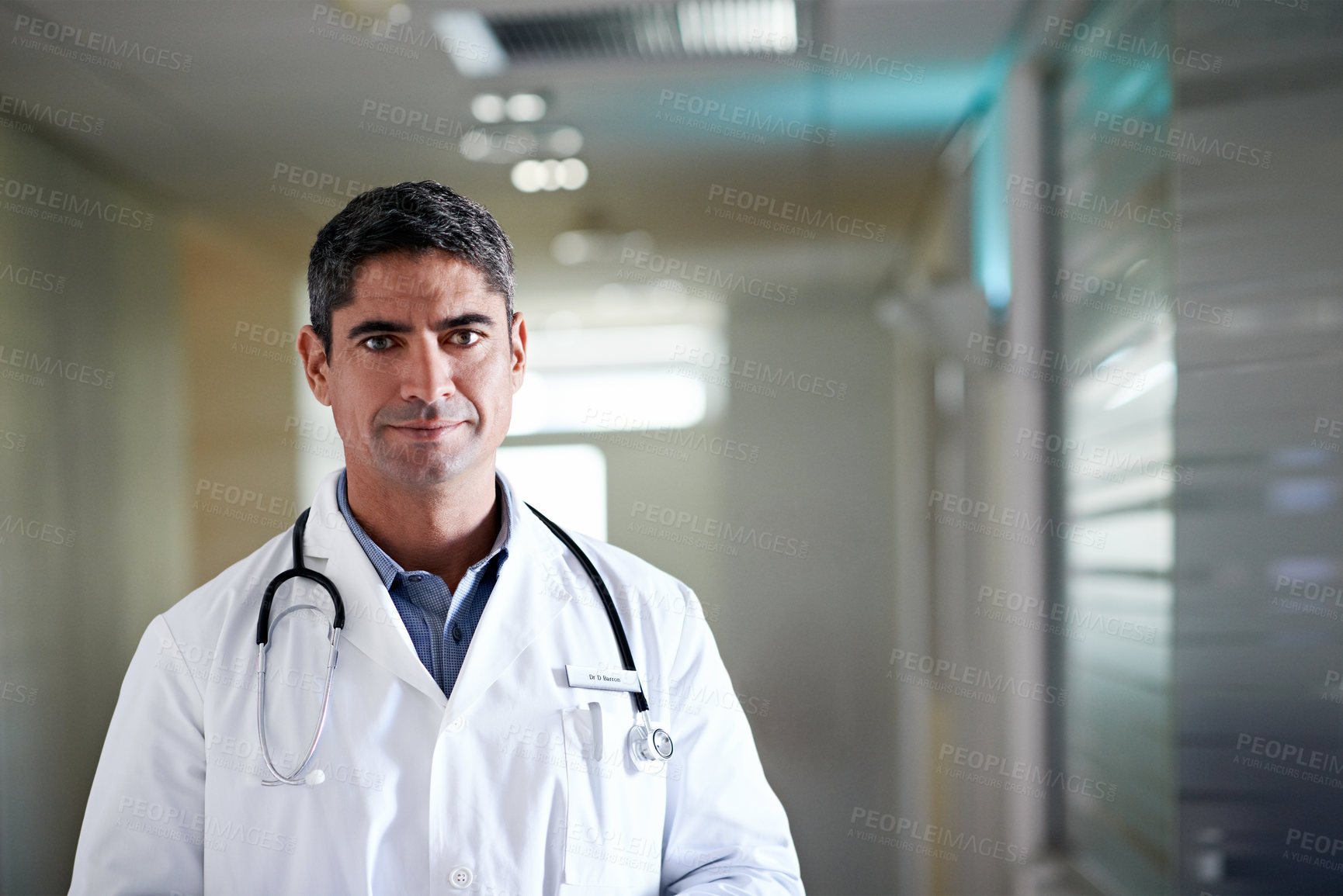 Buy stock photo Portrait, doctor and man in hospital for healthcare service, career integrity and experience at hallway. Male person, medical professional and physician for wellness, space and confident in Canada