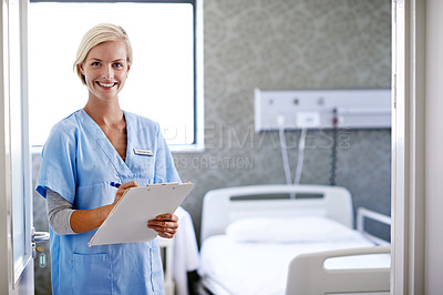 Buy stock photo Portrait of a young doctor with paperwork standing in a hospital ward