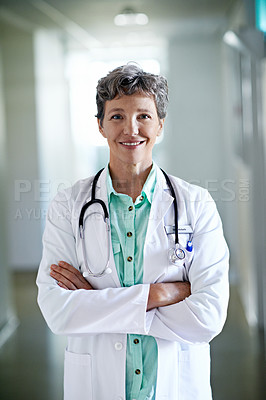 Buy stock photo Portrait of a mature female doctor standing in a hospital corridor