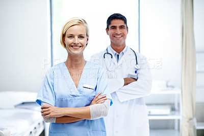 Buy stock photo Portrait of two confident doctors standing together in a hospital