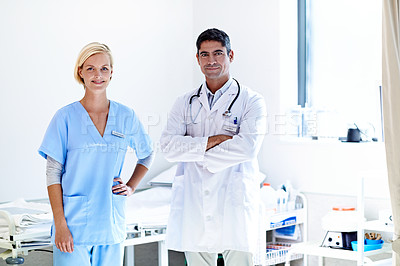 Buy stock photo Portrait of two confident doctors standing together in a hospital