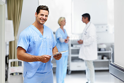 Buy stock photo Portrait of a male doctor with colleagues in the background