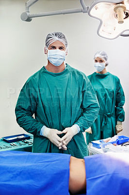 Buy stock photo Portrait of surgeons working on a patient in an operating room