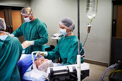 Buy stock photo Portrait of surgeons working on a patient in an operating room