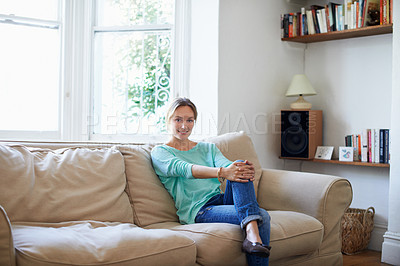 Buy stock photo Portrait of a woman relaxing on her living room sofa