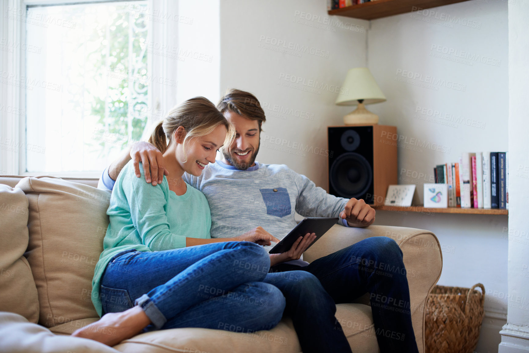 Buy stock photo Couple, laughing and online with tablet in lounge, love or watching movie with subscription in home. Happy people, scroll and streaming comedy with tech, entertainment and rest with partner in house