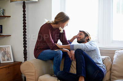Buy stock photo Shot of a loving young couple relaxing on a sofa at home