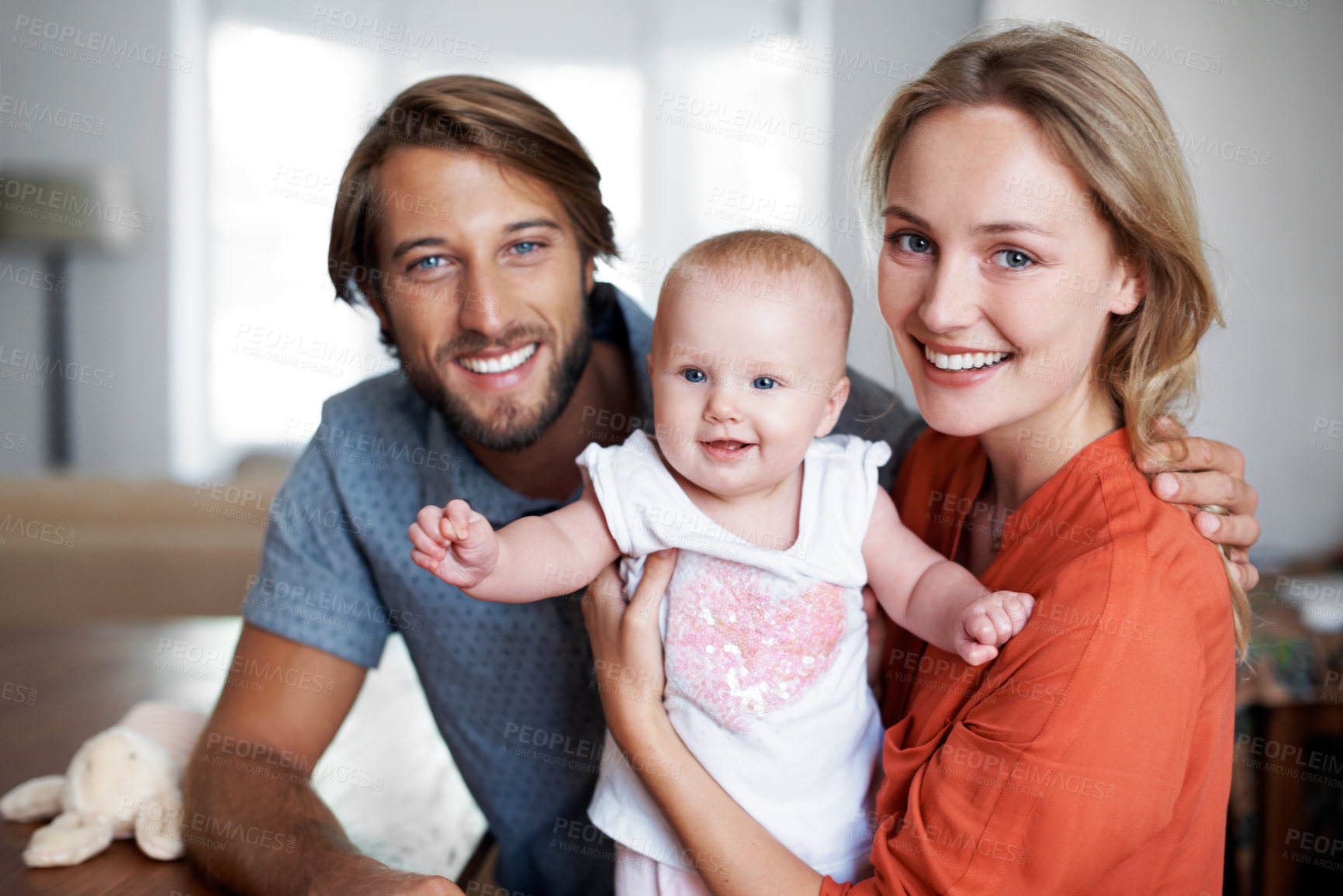 Buy stock photo Portrait of a young couple spending time with their baby girl