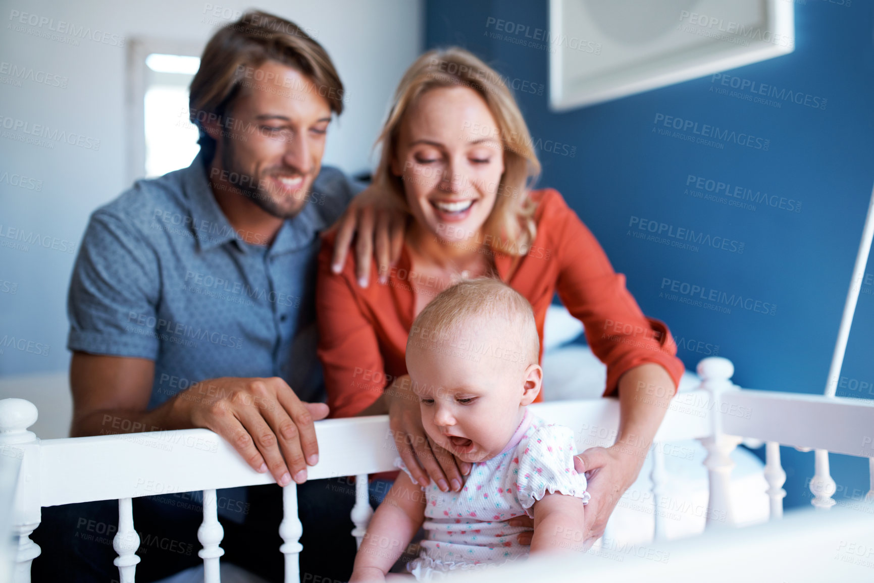Buy stock photo Shot of a young couple playing with their baby at home