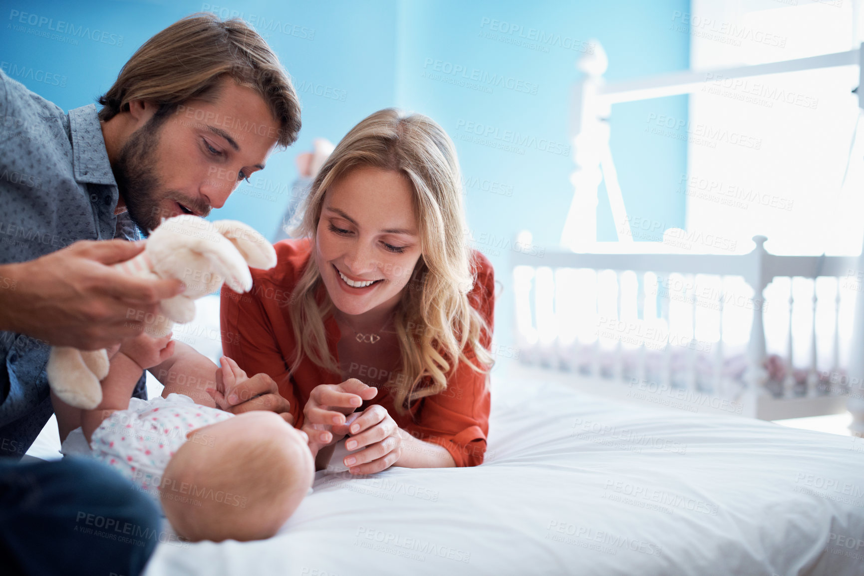 Buy stock photo Teddy bear, parents and bonding with baby on bed for healthy development, family and childcare. Toy, happy mother and dad with child in home bedroom for infant wellness, playing together and growth