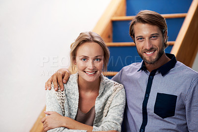 Buy stock photo Portrait of an affectionate couple sitting on the staircase at home