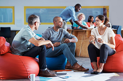 Buy stock photo Full length shot of businesspeople sitting on beanbag chairs in the office