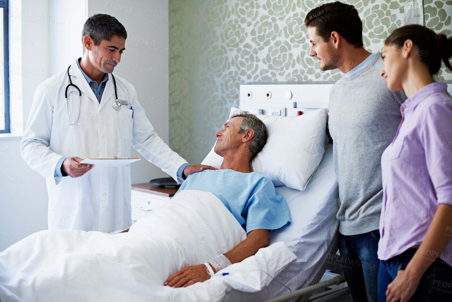 Buy stock photo Doctor, man and patient with family in hospital bed for medical results, diagnosis or news. Male person, healthcare worker or checkup with dad, adult son or daughter for treatment progress in clinic