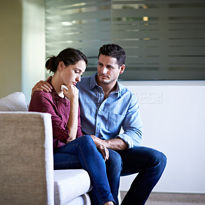 Buy stock photo Shot of a husband comforting his wife in a hospital waiting room