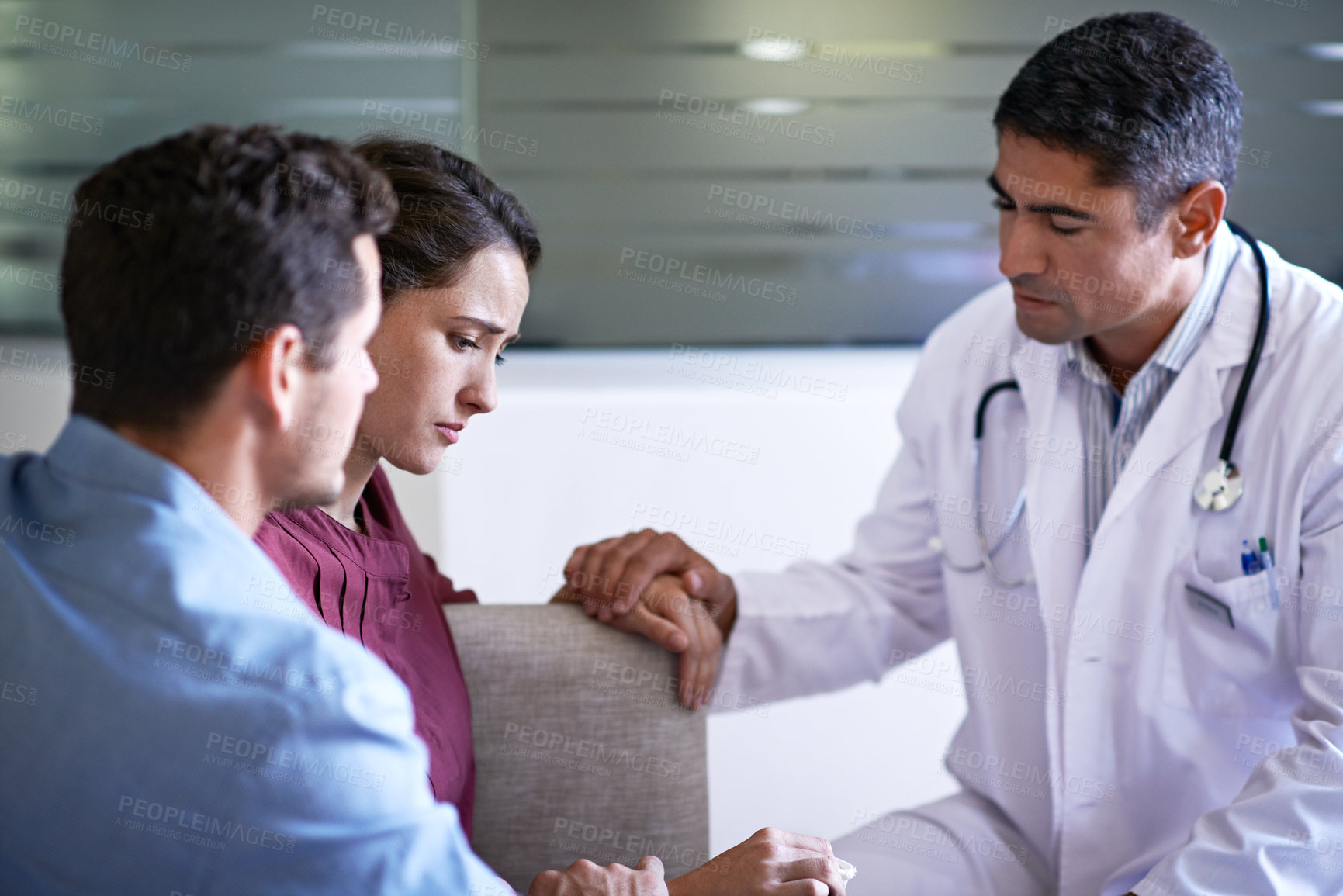 Buy stock photo Couple, difficult and doctor in hospital waiting room for healthcare discussion, feedback or review. Bad news, grief and medical professional speaking to sad people in lobby of clinic for report