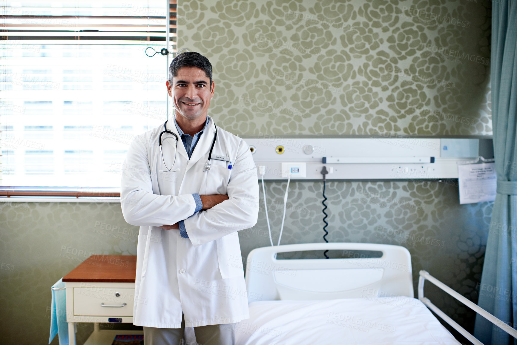 Buy stock photo Doctor, smile and man with arms crossed in hospital, health services or confident for career growth. Clinic, healthcare professional and happy person with medical duty, portrait and wellness job