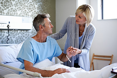 Buy stock photo Shot of a wife visiting her husband in the hospital