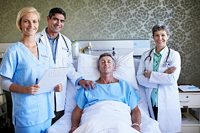 Buy stock photo Portrait of a team of medical professionals standing around a patient in a hospital bed