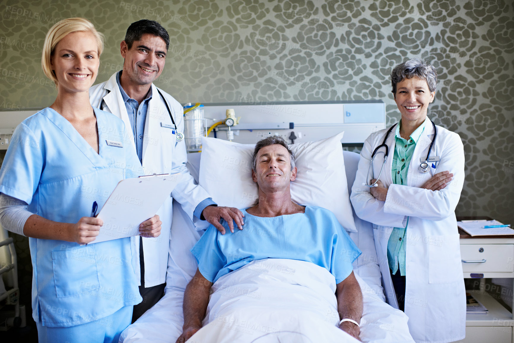Buy stock photo Hospital bed, man and portrait with doctor team for inpatient care, recovery progress or support. Happy staff, nurse or clipboard for post operation checkup, service or patient wellness in ward round
