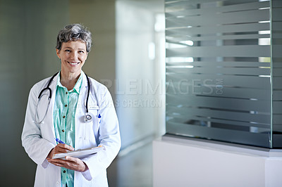 Buy stock photo Portrait of a mature female doctor standing in a hospital corridor