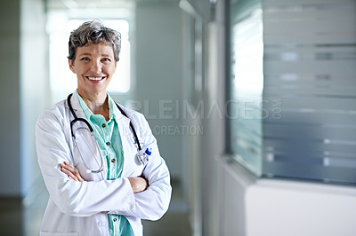 Buy stock photo Portrait of a mature female doctor standing in a hospital corridor