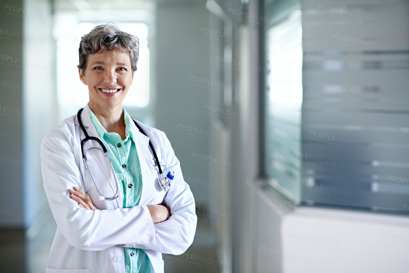 Buy stock photo Crossed arms, portrait and doctor in hospital lobby for wellness, medical service and healthcare. Happy, mature and confident woman in clinic for health career, support and pride for about us