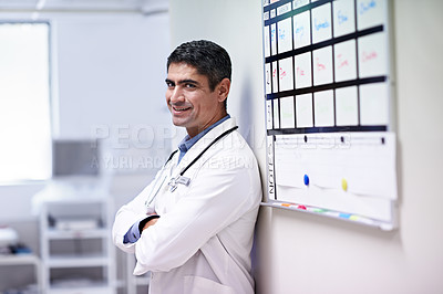Buy stock photo Portrait of a doctor standing by a shift schedule in a hospital