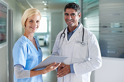 Buy stock photo Portrait of a two medical professionals standing in a hospital corridor