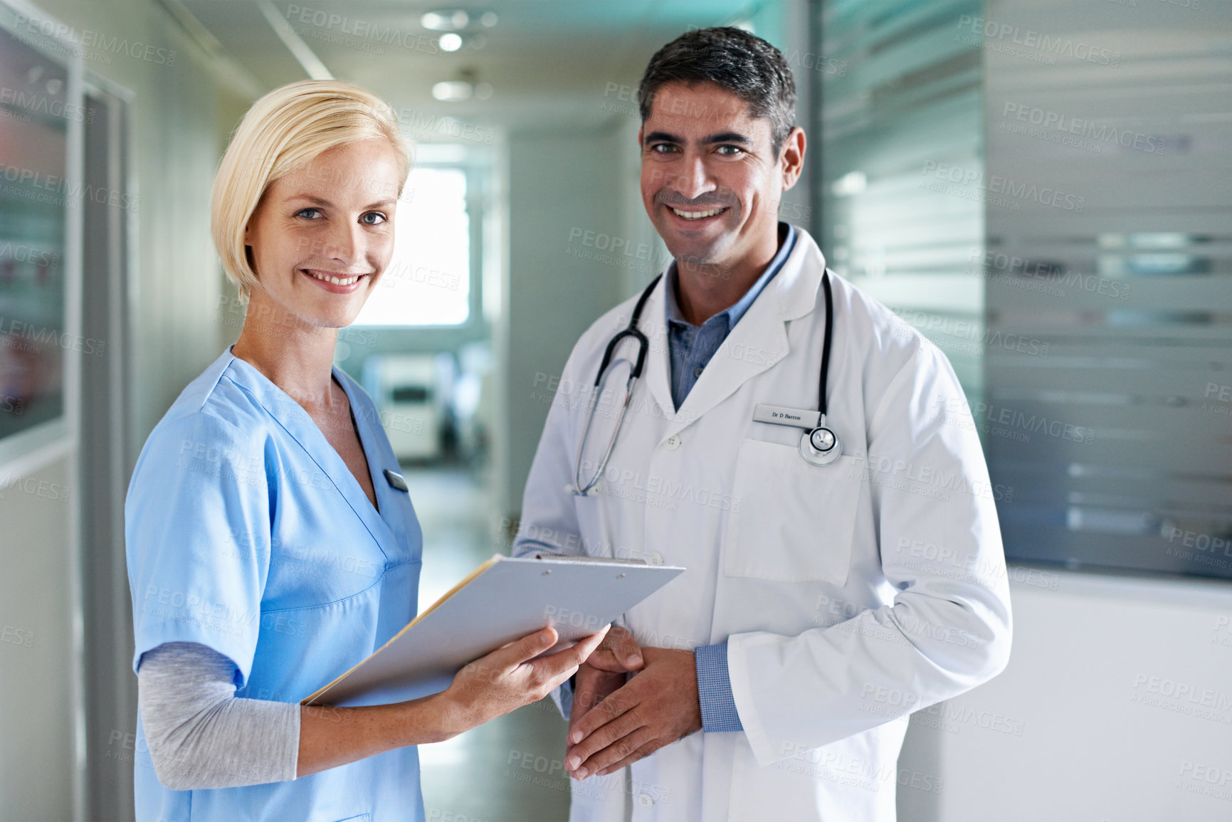 Buy stock photo Portrait of a two medical professionals standing in a hospital corridor