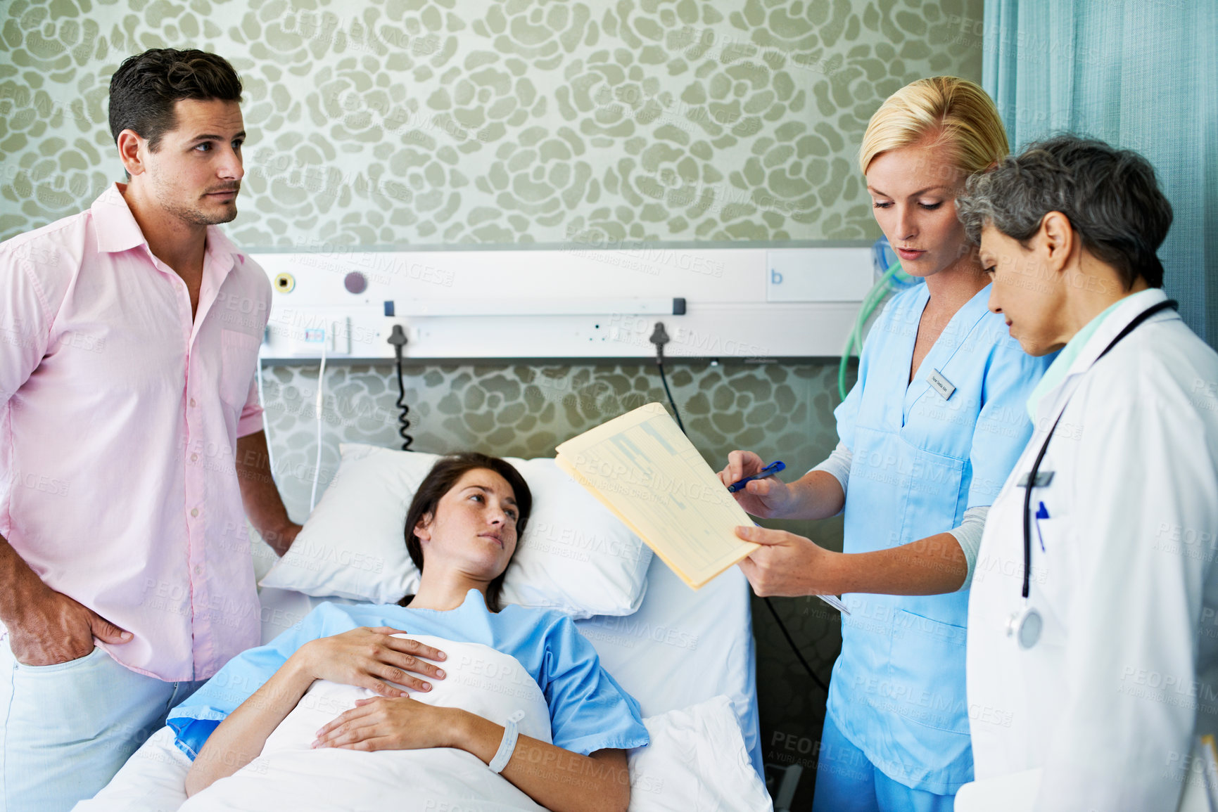 Buy stock photo Doctor, couple and nurse with patient in hospital bed for medical diagnosis, checkup or results. Healthcare worker, man and woman with documents for health recovery, support or treatment in clinic