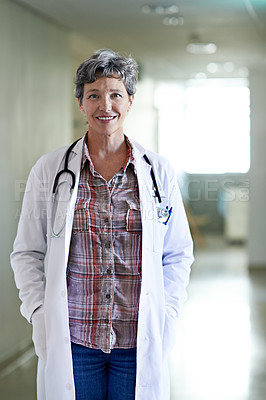 Buy stock photo Portrait of a mature female doctor standing in a hospital corridor