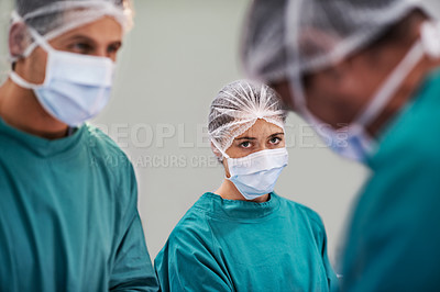 Buy stock photo Shot of a team of surgeons performing an operation