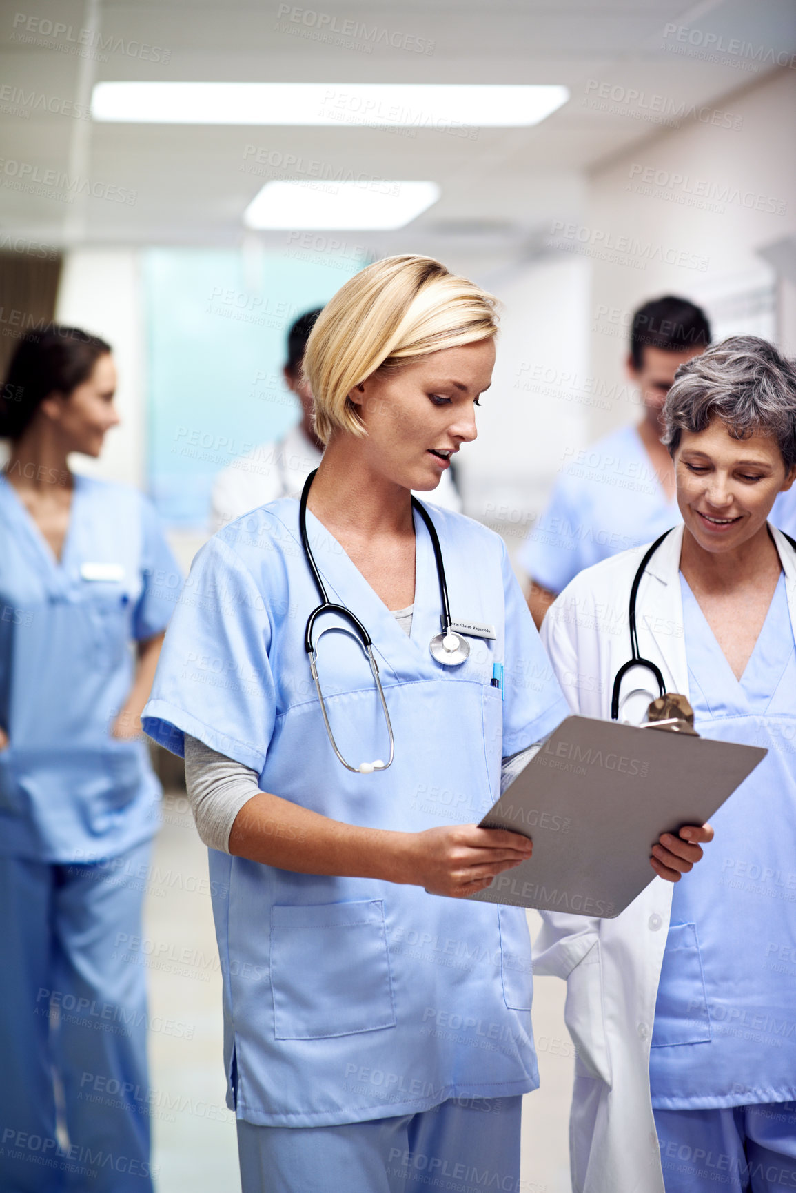 Buy stock photo Hospital, doctors and women with clipboard, healthcare or discussion with intern for treatment plan. Medical professional, mentor and people with checklist, collaboration and reading health report