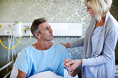 Buy stock photo Shot of a wife visiting her husband in the hospital