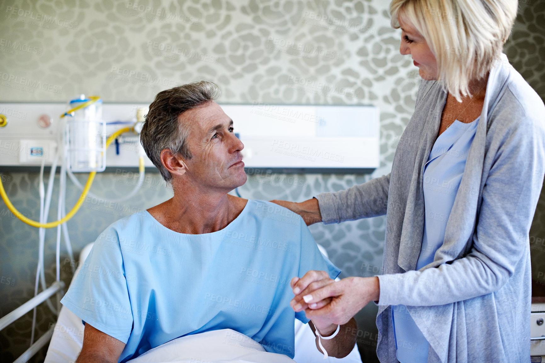 Buy stock photo Support, help and holding hands with couple in hospital for medical recovery, connection or worry. Healthcare treatment, icu healing and love with mature man and woman in clinic for trust and empathy