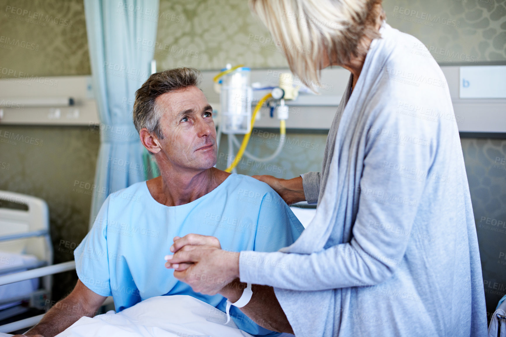 Buy stock photo Shot of a wife visiting her husband in the hospital
