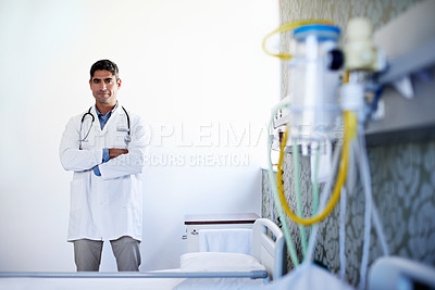 Buy stock photo Portrait of a mature male doctor standing in a hospital ward