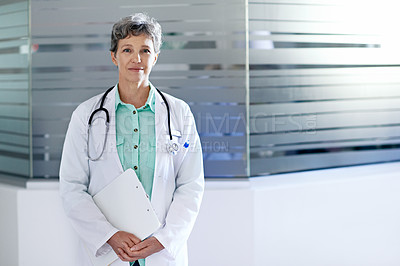 Buy stock photo Portrait of a mature female doctor standing in a hospital corridor