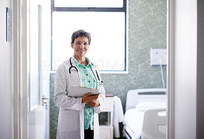 Buy stock photo Portrait of a mature female doctor standing in a hospital ward