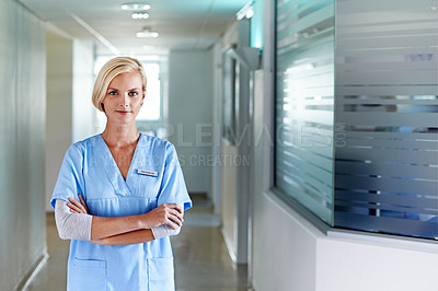 Buy stock photo Portrait of a young nurse standing in a hospital corridor