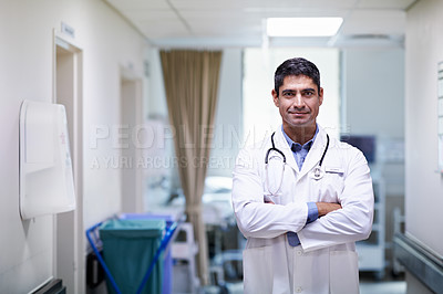 Buy stock photo Portrait of a confident-looking doctor standing in a hospital corridor