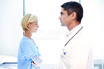 Buy stock photo Profile shot of two medical professionals standing in a hospital ward