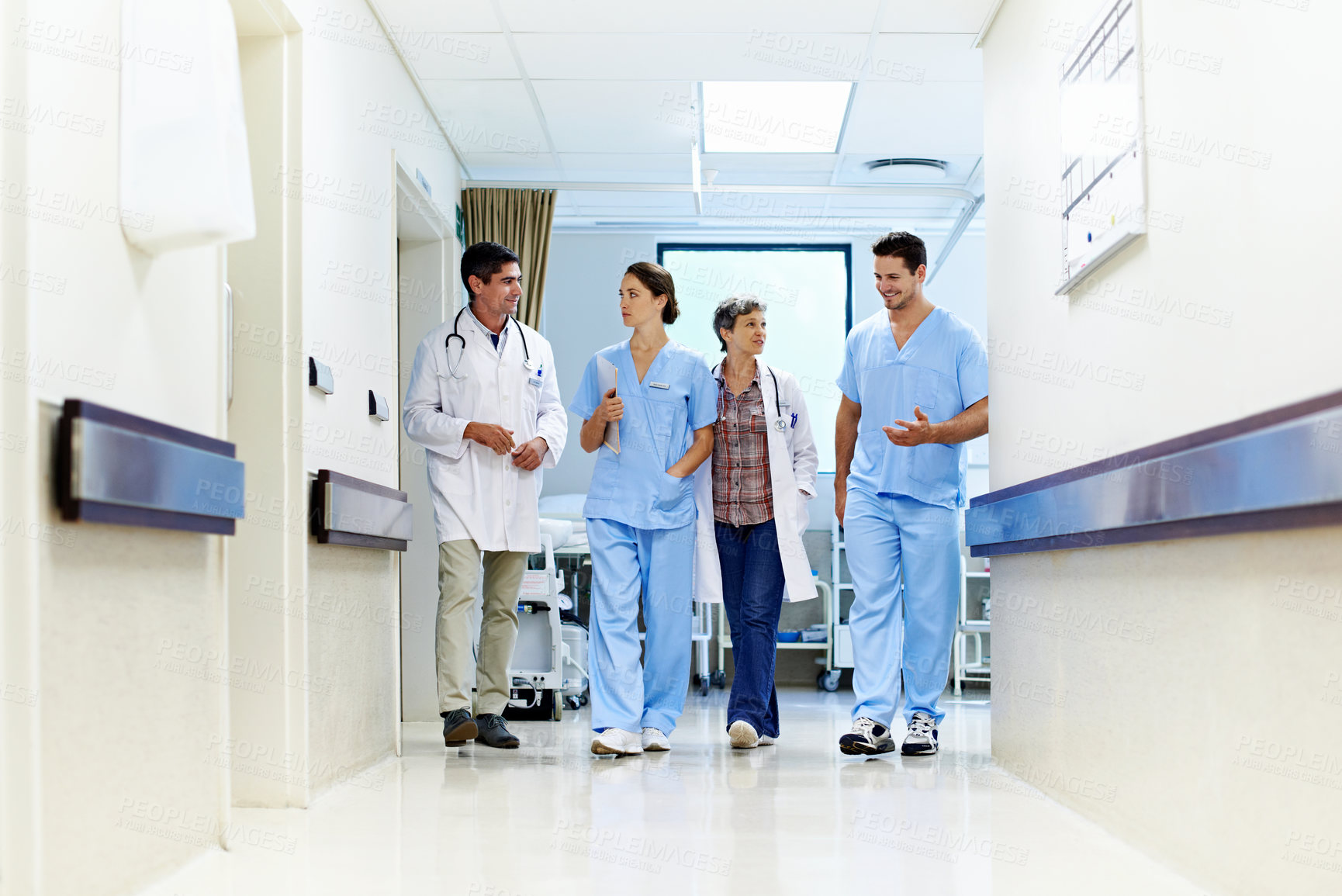 Buy stock photo Team, hospital and doctors walking in corridor for discussion, patient feedback and consulting. Healthcare, nurses and people in hallway for talking, collaboration and meeting for medical service