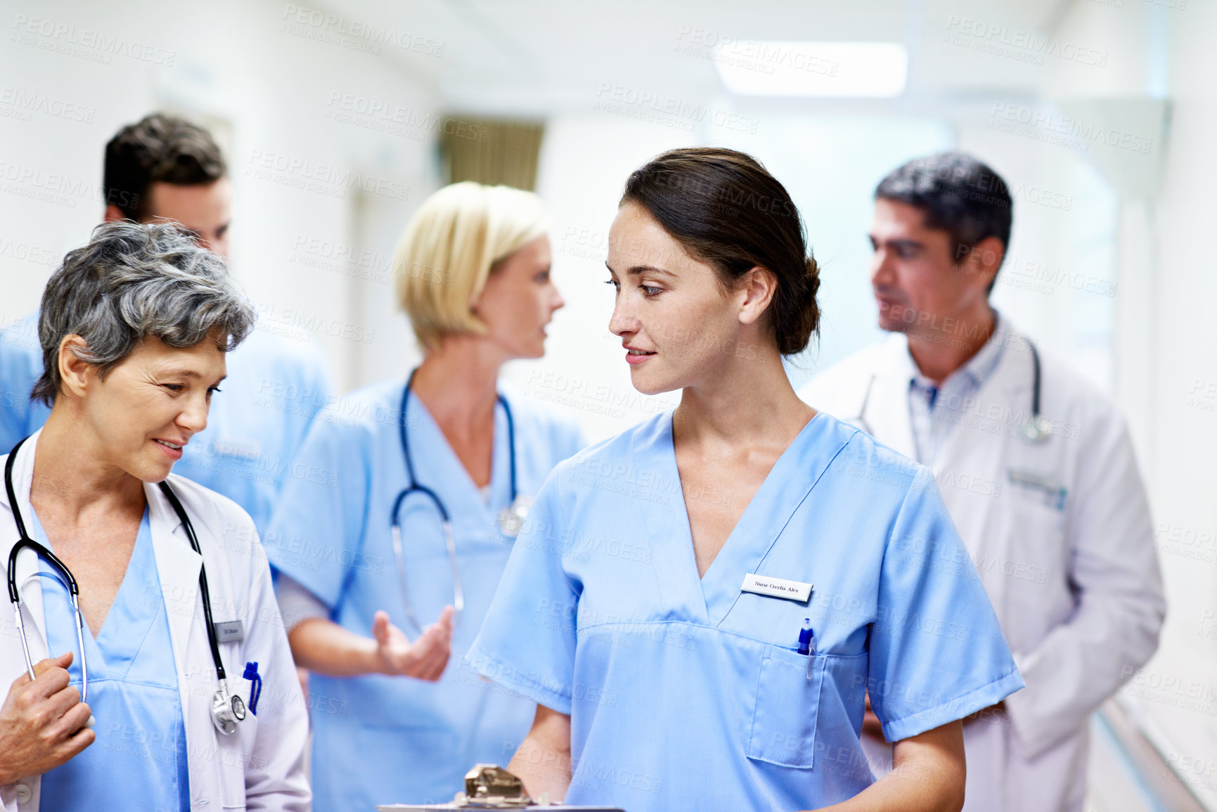 Buy stock photo Clinic, team or walk with medical checklist for shift handover, health update or care coordination. Happy people, doctor or nurse with clipboard in hallway for ward round, healthcare plan or feedback