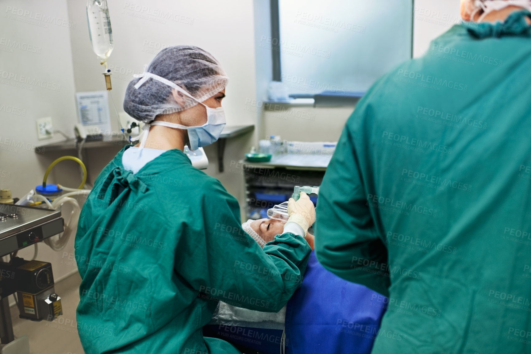 Buy stock photo Doctor, patient and surgery with team in operating room for medical emergency or procedure together. Woman, surgeon or face mask with operation, anesthesia or sedation in scrubs for healthcare in ICU