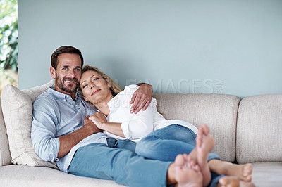 Buy stock photo Shot of a loving couple relaxing on their living room sofa