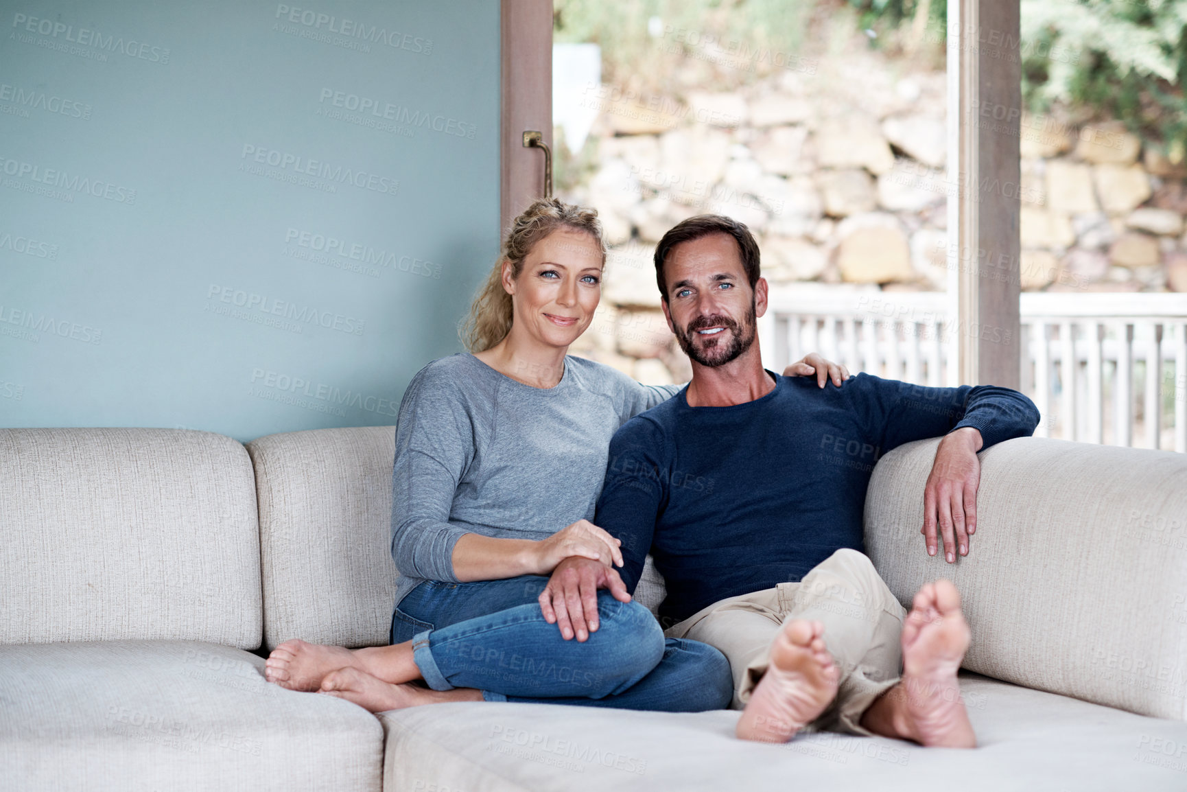 Buy stock photo Portrait, couple and relax on sofa with smile, love and bonding together for stress relief. Happy, mature people or comfort at house with partner, connection or healthy relationship for weekend break